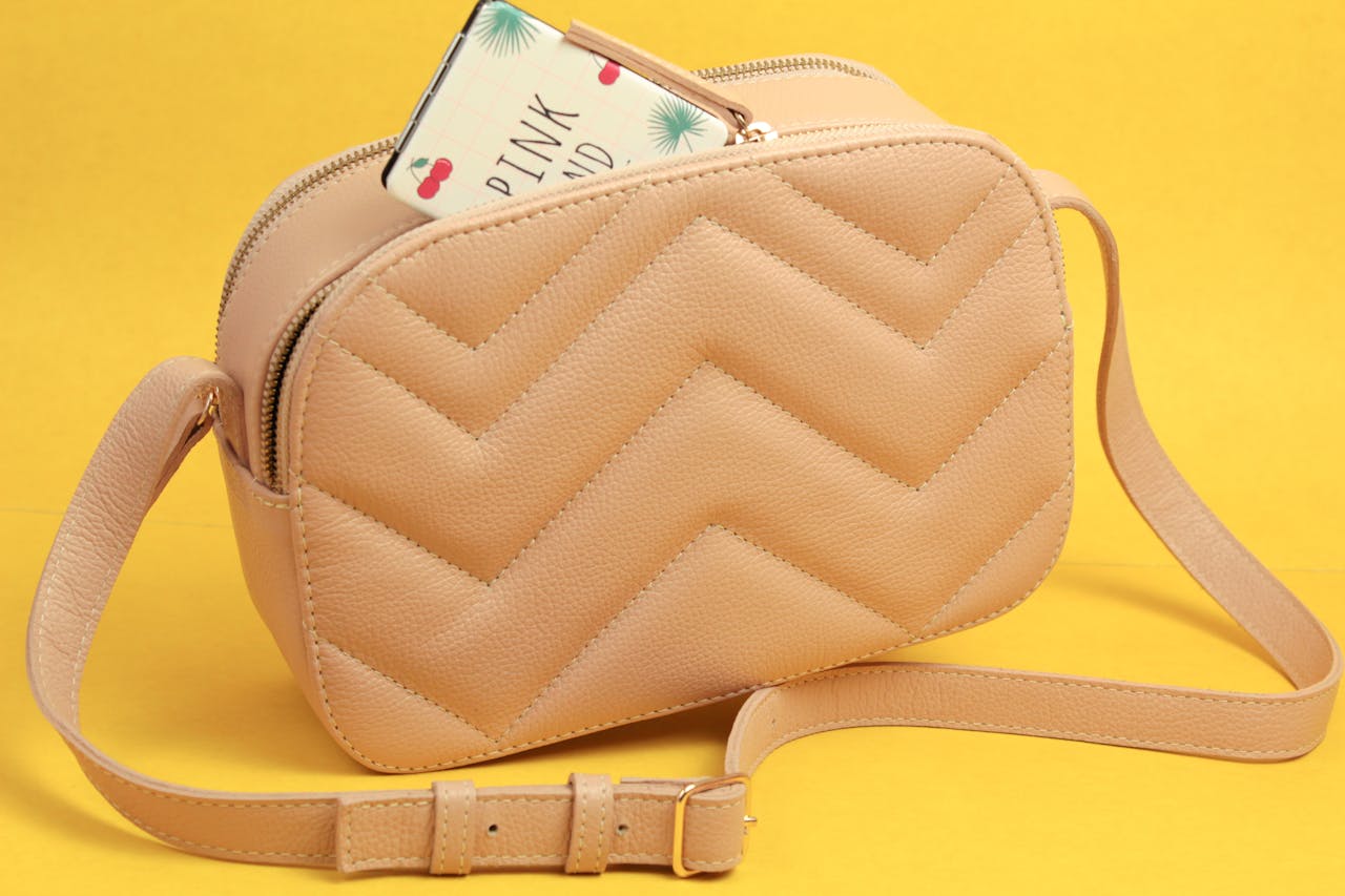 Elegant beige handbag on a vibrant yellow background, perfect for fashion themes.